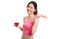 Healthy Asian girl diet with tomato juice and measuring tape on Royalty Free Stock Photo