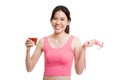 Healthy Asian girl diet with tomato juice and measuring tape on Royalty Free Stock Photo