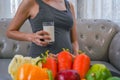 The healthy Asian pregnant young woman with a glass of milk and with many kinds of fruit and vegetable