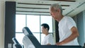 Healthy Asian senior couple exercise together in gym running treadmill Royalty Free Stock Photo