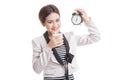 Healthy Asian woman drinking glass of milk hold clock. Royalty Free Stock Photo