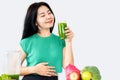 Healthy Asian woman drinking mix of green vegetables and fruit juice for detox Royalty Free Stock Photo