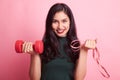 Healthy Asian woman with dumbbells and measuring tape.