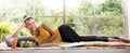 Healthy Asian woman lying on the floor eating salad looking relaxed and comfortable Royalty Free Stock Photo