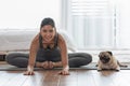 Healthy Asian woman practice yoga with dog pug breed enjoy and relax Royalty Free Stock Photo