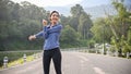 Healthy Asian woman in sportswear is stretching her arms and body before running Royalty Free Stock Photo