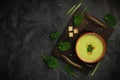 Healthy asparagus soup in a bowl over dark wooden cutting board, concrete background.Top view with copy space Royalty Free Stock Photo