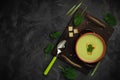 Healthy asparagus soup in a bowl over dark wooden cutting board, concrete background.Top view with copy space Royalty Free Stock Photo