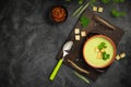 Healthy asparagus soup in a bowl over dark wooden cutting board, concrete background.Top view with copy space Royalty Free Stock Photo