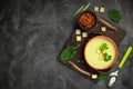 Healthy asparagus soup in a bowl over dark wooden cutting board, concrete background.Top view with copy space Royalty Free Stock Photo