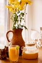 Healthy autumn glass teapot of natural sea buckthorn tea. Organic increased immunity herbal tea at cozy home