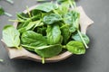 Healthy baby spinach leaves in wooden bowl closeup Royalty Free Stock Photo