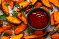 Healthy Baked Orange Sweet Potato wedges with dip sauce, herbs, salt and pepper