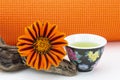 Healthy balance seen in yoga mat, natural flower, and green tea