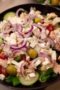 Healthy and balanced bowl of salad featuring diced red onions, green olives and juicy tomatoes Royalty Free Stock Photo