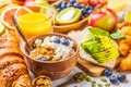 Healthy balanced breakfast on a white background. Muesli, juice, croissants, cheese, biscuits and fruit breakfast backgound Royalty Free Stock Photo