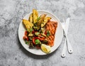 Healthy balanced lunch - grilled salmon, baked ratatouille and potatoes on a gray background, top view Royalty Free Stock Photo