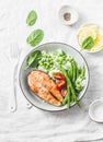 Healthy balanced meal lunch plate - baked salmon with rice and vegetables on a light background Royalty Free Stock Photo