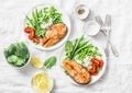 Healthy balanced mediterranean diet lunch - baked salmon, rice, green peas and green beans on a light background, top view.