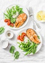 Healthy balanced mediterranean diet lunch - baked salmon, rice, green peas and green beans on a light background, top view. Royalty Free Stock Photo
