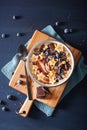 Healthy banana smoothie bowl with blueberry chocolate walnuts