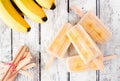 Healthy banana yogurt popsicle table scene over rustic white wood Royalty Free Stock Photo