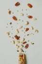 Healthy bar with nuts and seeds on the gray background, top view