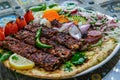 Healthy barbecue different meat with vegetables and sauce. served with a black plate. close up view on a light background. Arabic Royalty Free Stock Photo