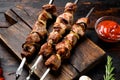 Healthy barbecued lean cubed pork kebab , on old dark wooden table background