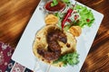 Healthy barbecued lean cubed pork kebabs served with a corn tortilla and fresh lettuce and tomato salad, close up view