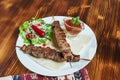 Healthy barbecued lean cubed pork kebabs served with a corn tortilla and fresh lettuce and tomato salad, close up view Royalty Free Stock Photo