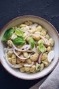 Healthy bean salad with green pesto, red onion and basil in a bowl.