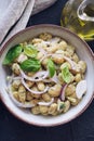 Healthy bean salad with green pesto, red onion and basil in a bowl.