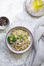 Healthy bean salad with green pesto, red onion and basil in a bowl.