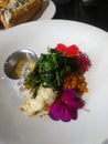 Healthy beautiful dinner of Triple Tail Fish and Sweet Potato Hash decorated with flowers