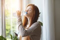 Beautiful red haired young woman drinking water Royalty Free Stock Photo