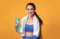 Sporty woman looking at camera holding water bottle Royalty Free Stock Photo