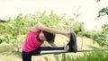 Healthy beautiful young Asian Athlete women in sports clothing legs warming and stretching her arms to ready for running on street Royalty Free Stock Photo