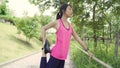 Healthy beautiful young Asian Athlete women in sports clothing legs warming and stretching her arms to ready for running on street Royalty Free Stock Photo