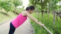 Healthy beautiful young Asian Athlete women in sports clothing legs warming and stretching her arms to ready for running on street Royalty Free Stock Photo