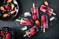 Healthy berry fruit popsicles, top view with stone server
