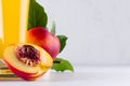 Healthy beverage - fresh juice of nectarines and ingredients - half nectarine with seed closeup on light white wooden board. Royalty Free Stock Photo