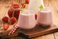 Healthy beverage- strawberry milkshake in glasses on wooden background. Royalty Free Stock Photo