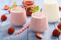 Healthy beverage- strawberry milkshake in glasses on wooden background. Royalty Free Stock Photo