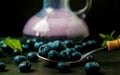 Healthy Black berries drink on a table with berries and mint next by