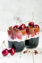 Healthy Black Forest dessert. Black activated charcoal chia pudding with cherries, coconut cream and chocolate. Vegan breakfast Royalty Free Stock Photo