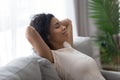 Healthy black girl resting breathing air sit on comfortable sofa Royalty Free Stock Photo