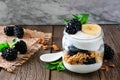 Blackberry and banana yogurt parfait in a mason jar on a dark background