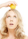 Healthy blond holding lemon on