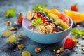 A healthy bowl of fruit topped with granola and mint is served Royalty Free Stock Photo